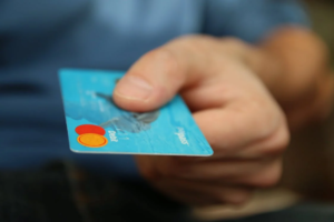 A man holding a card for payment