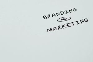 Text reading “brand and marketing” written on white surface