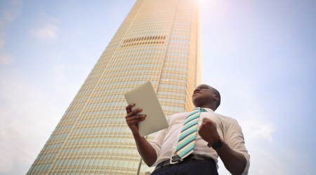 Businessman Standing Next to a Building